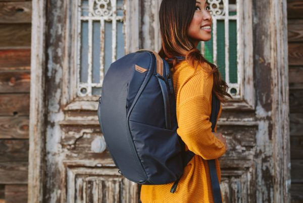 A photo of a woman with a backpack on.