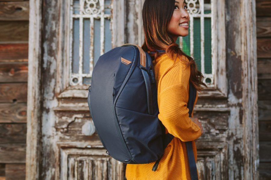 A photo of a woman with a backpack on.